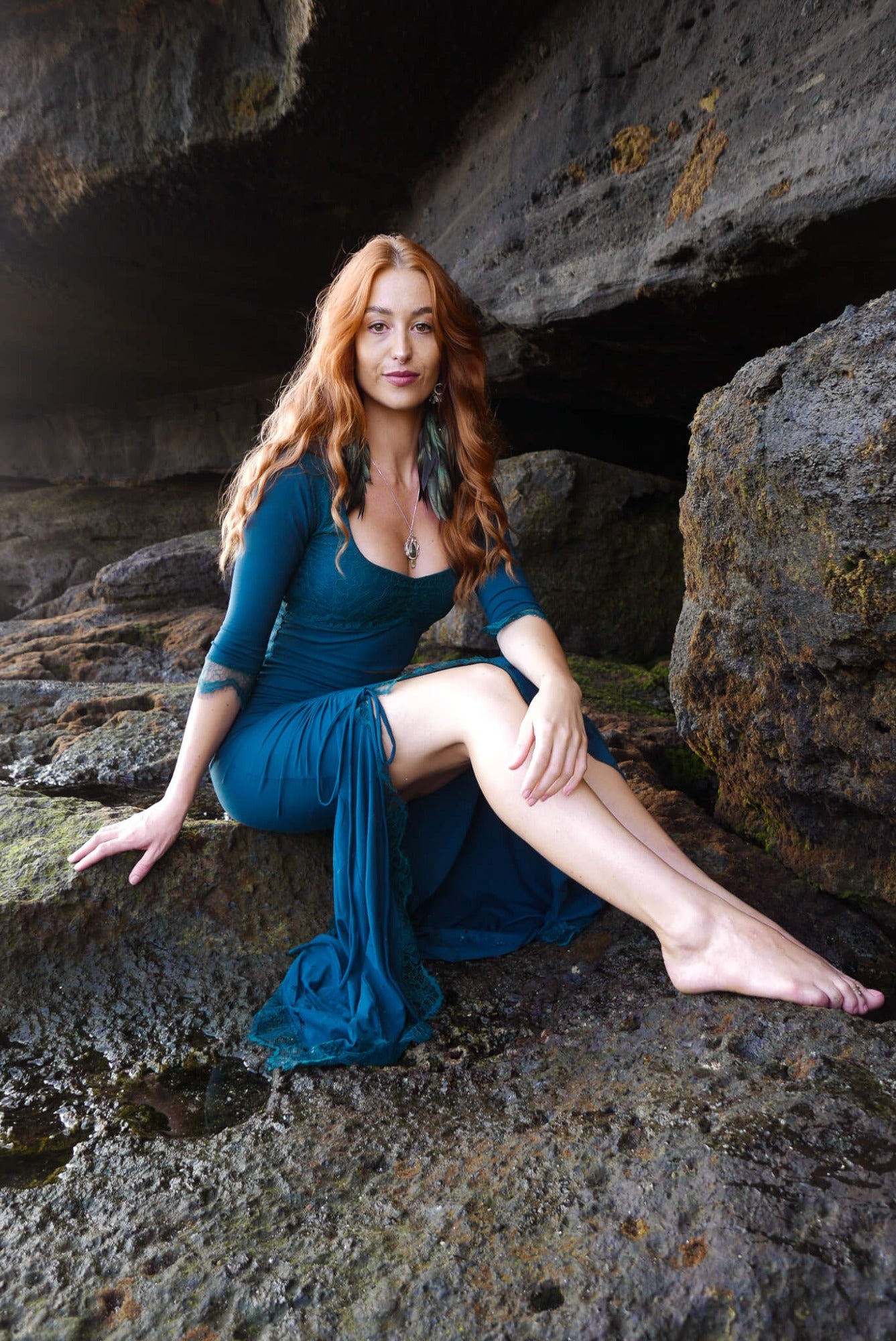 Mermaid lace -skirt and lace crop top in dark teal combined with black feather earrings.