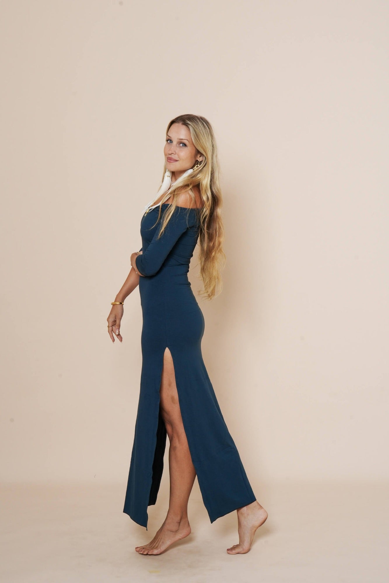 Off shoulder long dress with side cuts and 3/4 sleeves in color dark teal.