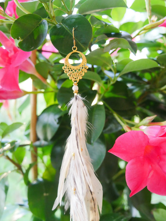 Bohemian Goddess Long Single Feather Earring named Sunlight with a gold plated chandelier, yellow creamy colored feathers.