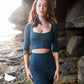 Lace crop top with mermaid lace skirt, combined with black feather earrings.