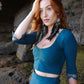 Lace crop top with mermaid lace skirt, combined with black feather earrings.