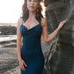Beautiful dress with open back, side cuts and delicate strap details crossing the back in color dark teal.