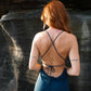 Beautiful dress with open back, side cuts and delicate strap details crossing the back in color dark teal.