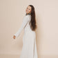 Long puffy sleeve vest in color winter white, combined with flair pants and halter top in color taupe.