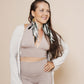 Long puffy sleeve vest in color winter white, combined with flair pants and halter top in color taupe, combined with Green topaz feather earrings.