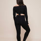 Charm off-shoulder wrap shirt black styled with leggings view from back
