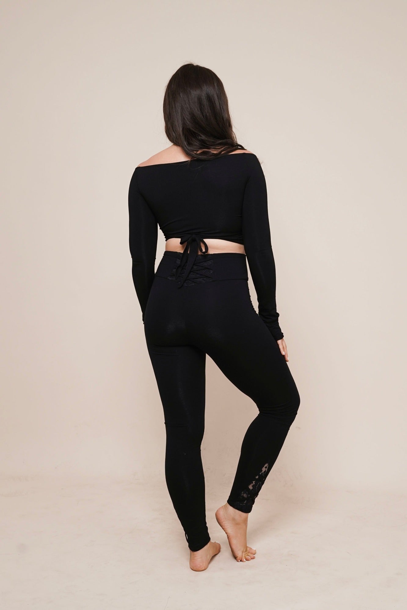 Charm off-shoulder wrap shirt black styled with leggings view from back