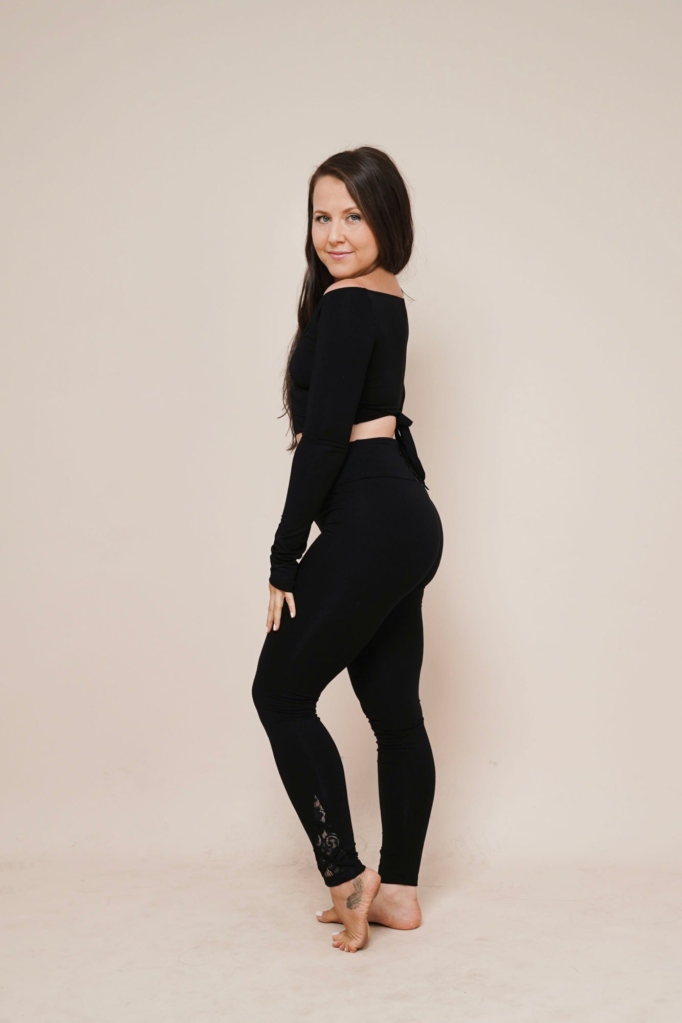 Charm off-shoulder wrap shirt black styled with leggings side view