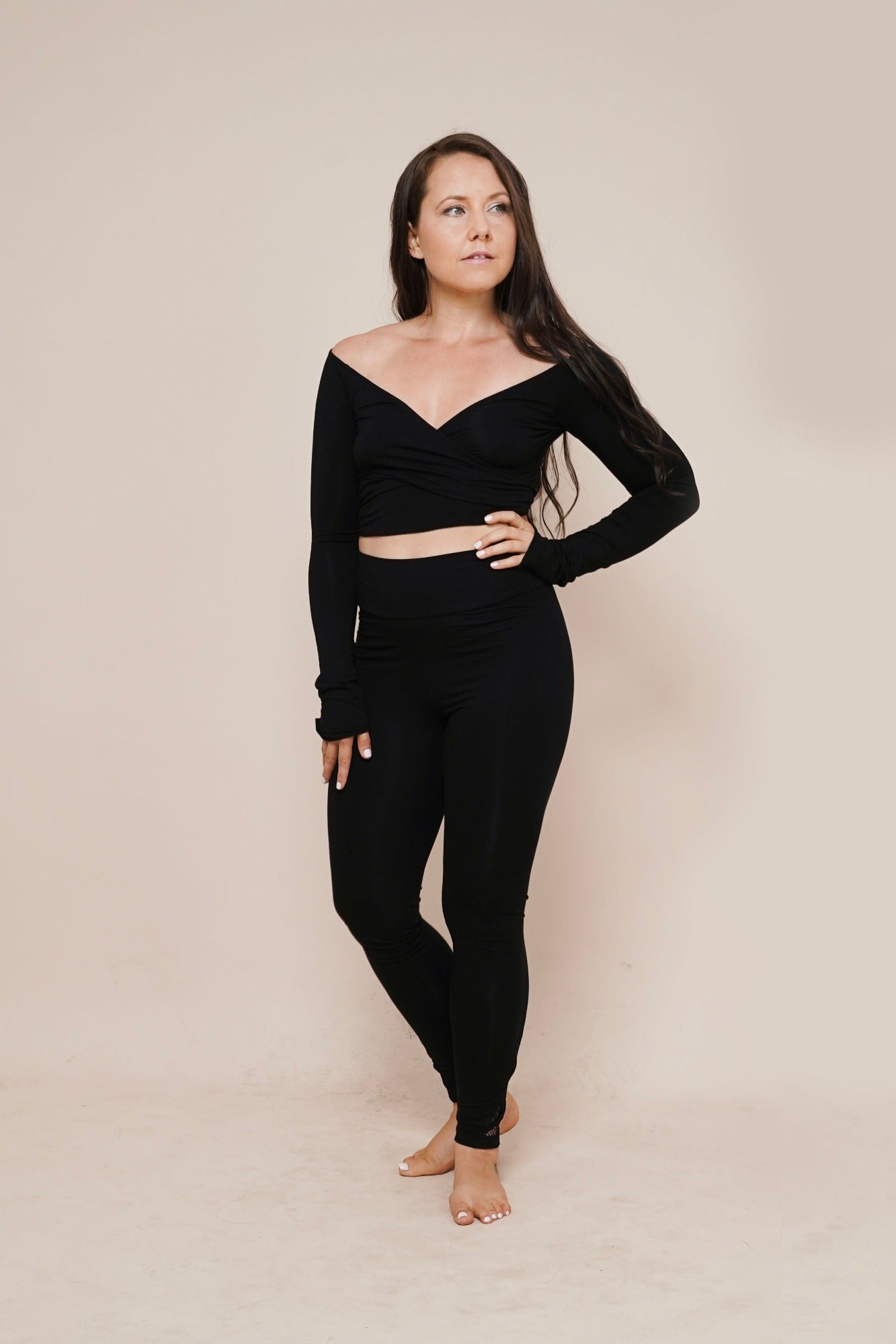 Charm off-shoulder wrap shirt black styled with leggings