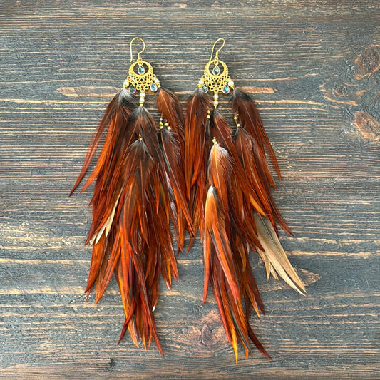 Gold-plated feather earrings with mystic topaz crystals and moon charm — handcrafted goddess jewelry