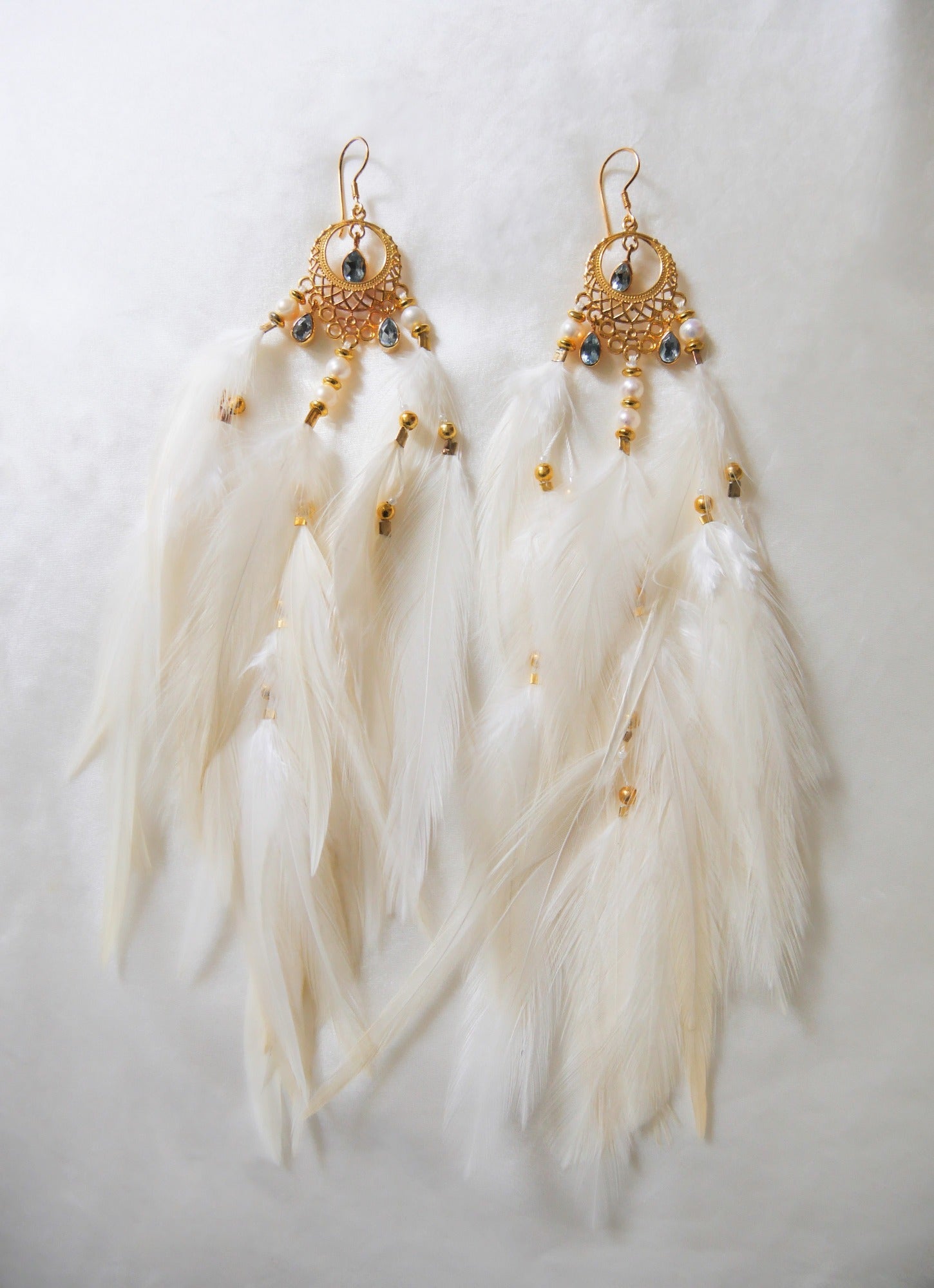 Bohemian Goddess long earrings named My truth sets me free with Blue Topaz crystals and white feathers.