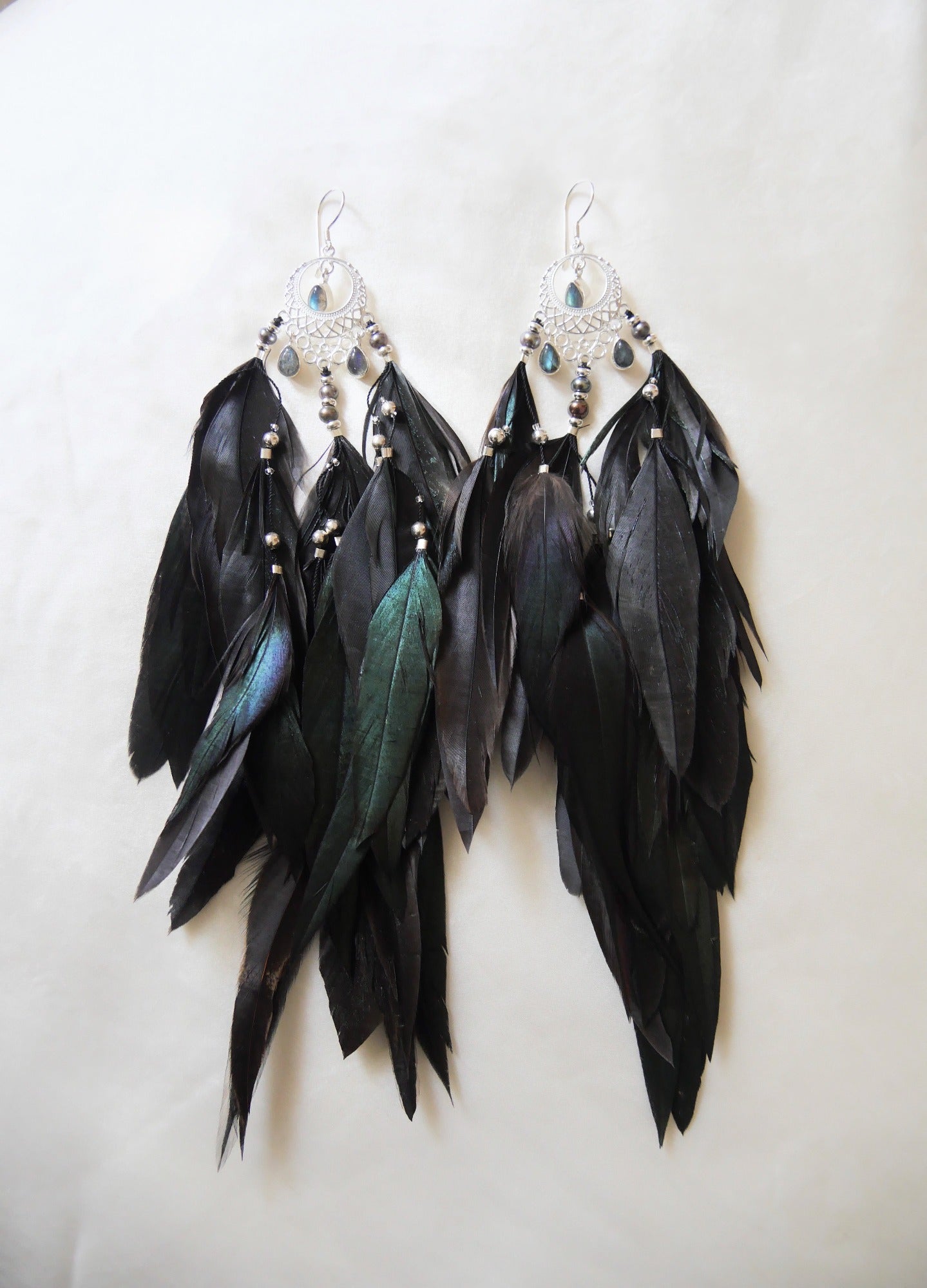 Bohemian Goddess long black feather earrings named My intuition is my superpower with Labradorite crystals.