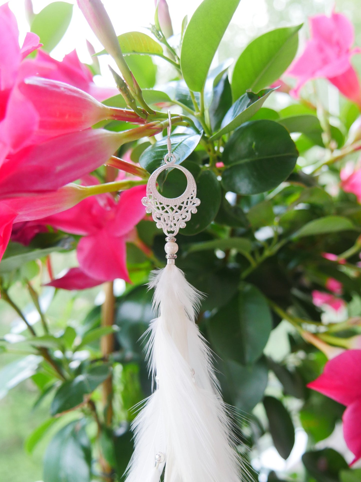 Bohemian Goddess 31 cm long single feather earring named Moonlight with white feathers.