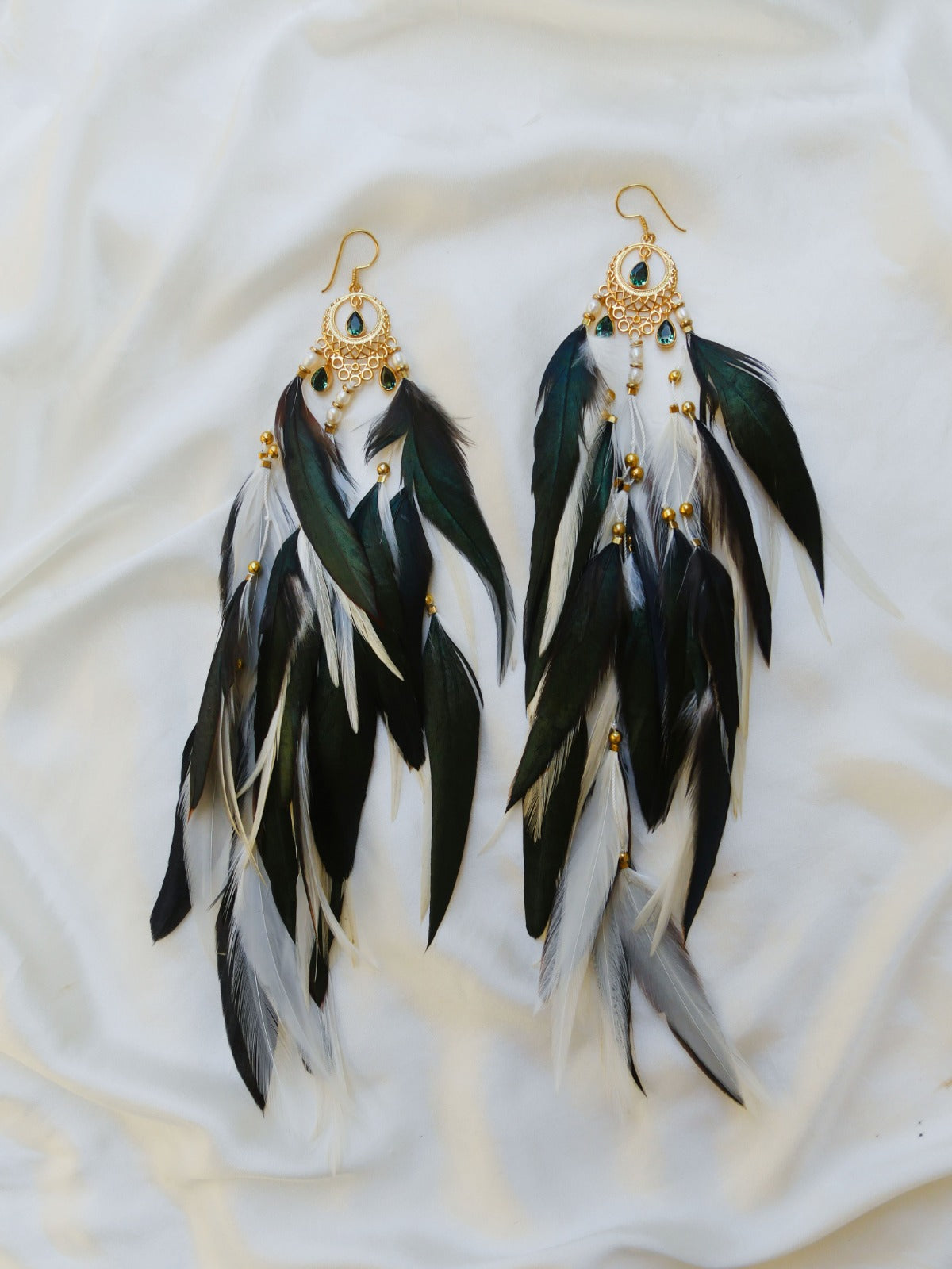 Bohemian Goddess long feather earrings with white and emerald green feathers, green quartz crystals and a gold plated brass moon chandelier.