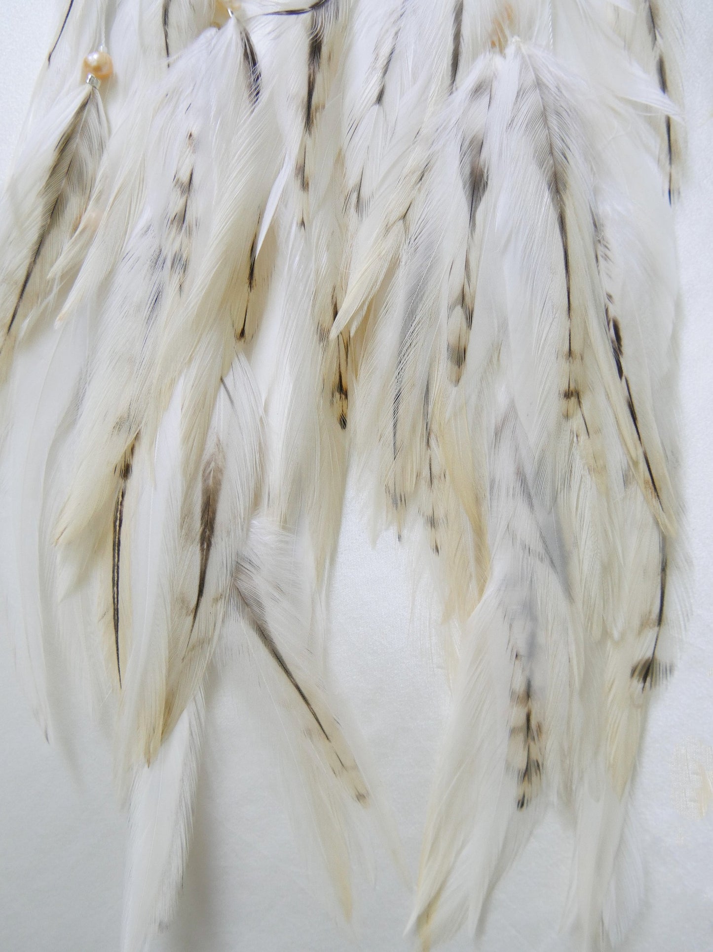 Rose quartz feather earrings with silver moon charm feather closeup 