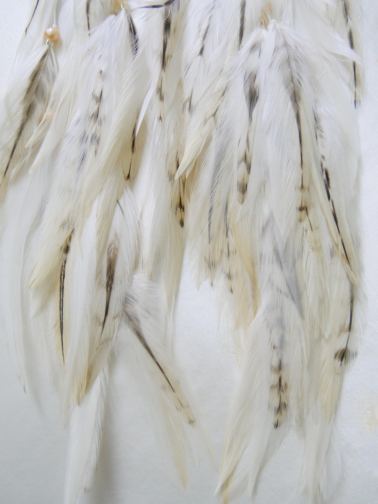 Rose quartz feather earrings with silver moon charm feather closeup 